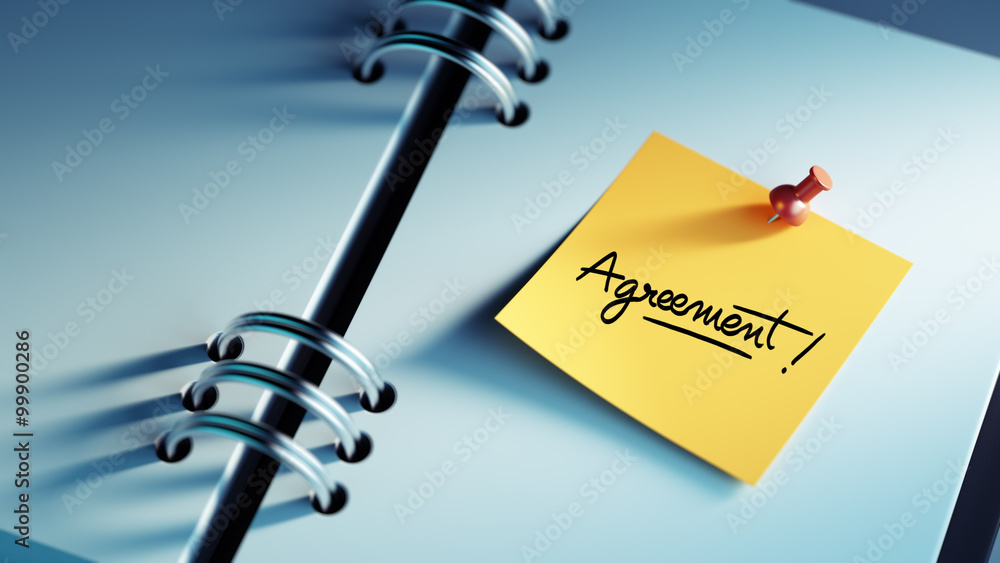 Obraz premium Closeup Yellow Sticky Note paste it in a notebook setting an app