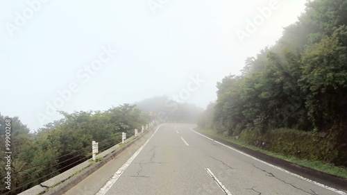 Driver's POV climbing a foggy road up the Hakone mountains.