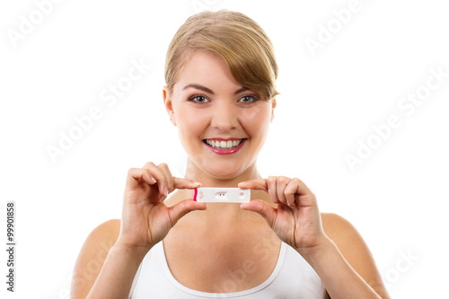 Happy woman showing pregnancy test with positive result