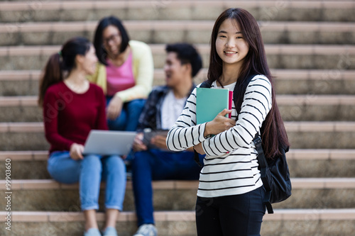 group of happy teen high school students outdoors