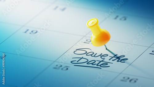 Concept image of a Calendar with a yellow push pin. Closeup shot