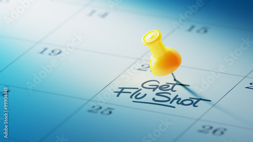 Concept image of a Calendar with a yellow push pin. Closeup shot