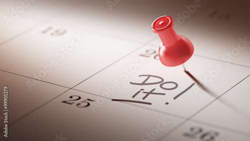 Concept image of a Calendar with a red push pin. Closeup shot of