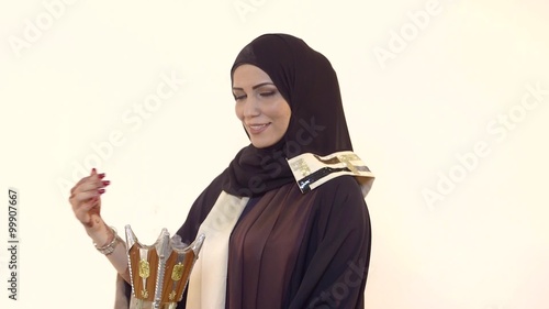 Arab woman holding incense burner. photo