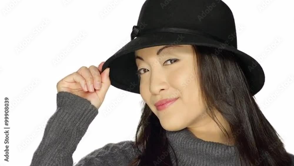 Beautiful ethnic woman smiling and wearing a hat, on a white studio background Beautiful ethnic woman smiling and wearing a hat, on a white studio background
