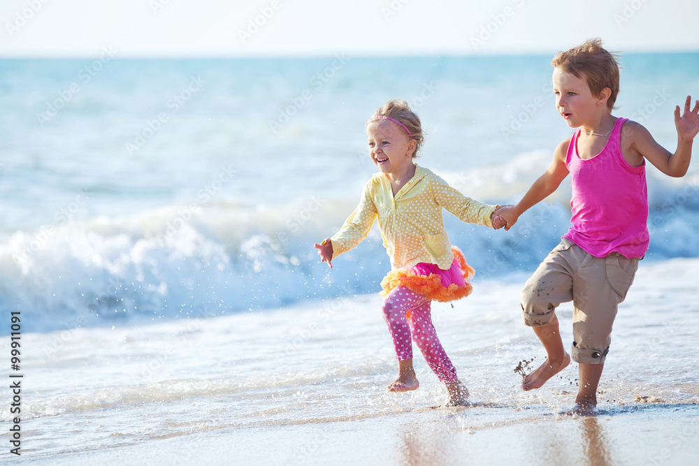 Happy kids are running on the beach Happy kids are running on the beach