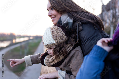 Happy mother and daughter having fun in the street.