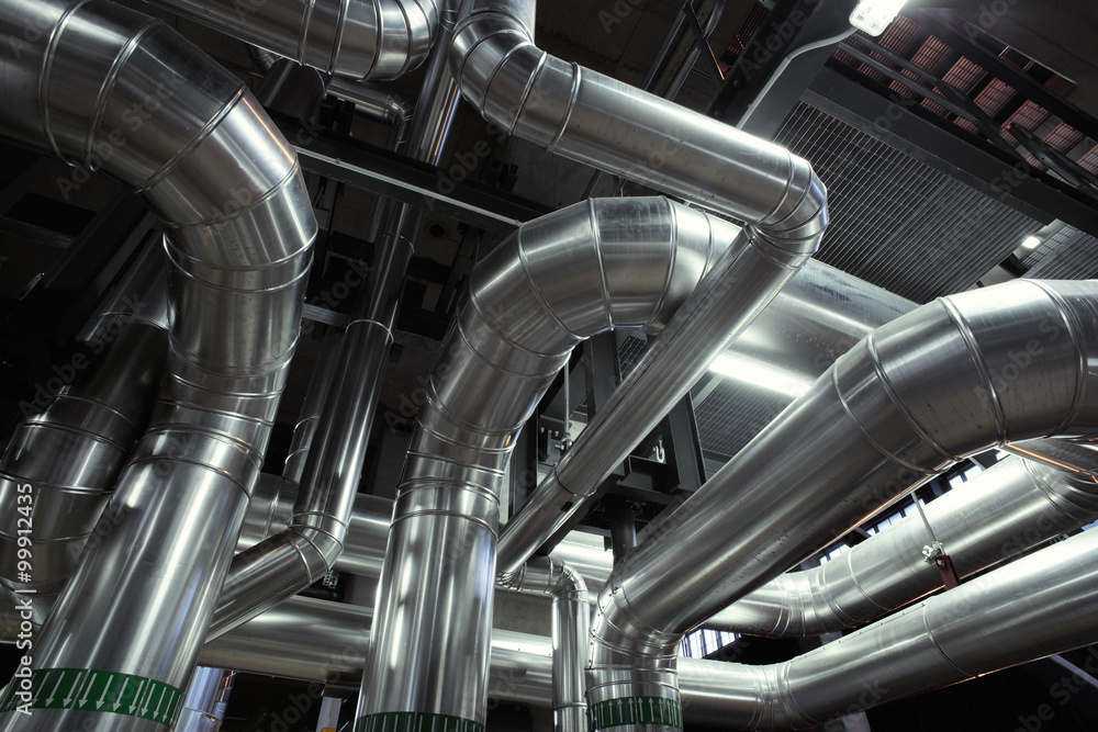 different size and shaped pipes and valves at a power plant different size and shaped pipes and valves at a power plant