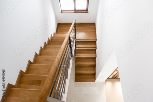 Interior design. Wooden minimalist staircase in luxury home. Modern Architectural loft with wooden steps