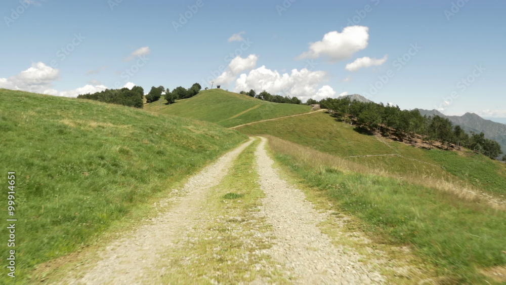 Walking along road in mountain nature scenery establishing gimbal steadicam Walking along road in mountain nature scenery establishing gimbal steadicam