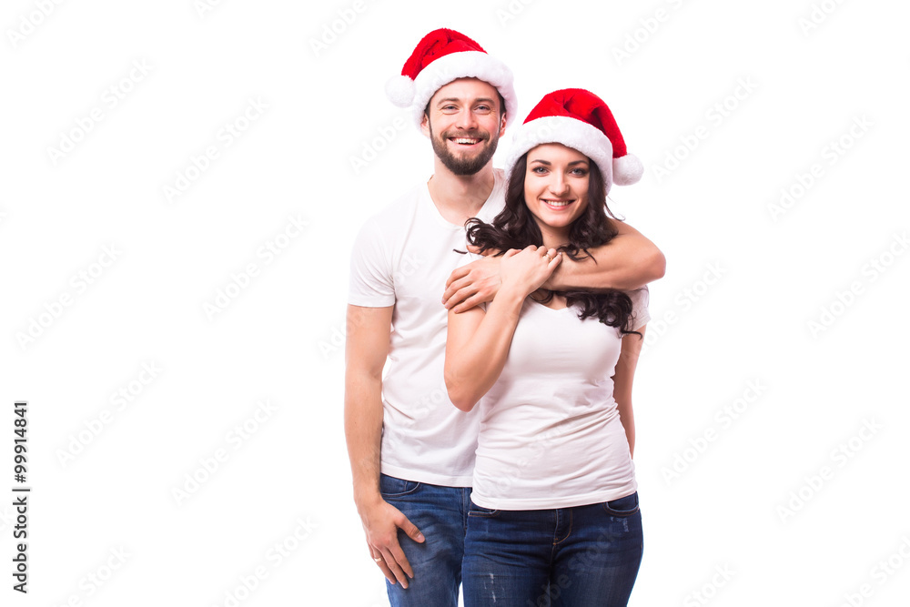 Happy couple with santa hat isolated over white background. Happy couple with santa hat isolated over white background.