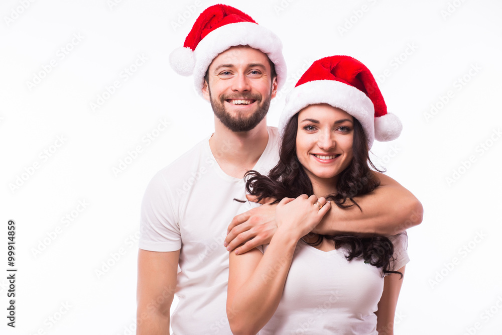 Happy couple with santa hat isolated over white background. Happy couple with santa hat isolated over white background.