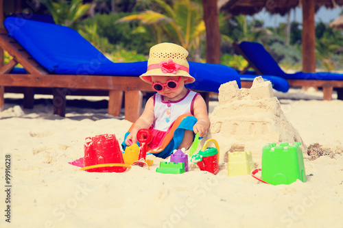 Wallpaper Mural cute little girl playing with sand on beach Torontodigital.ca