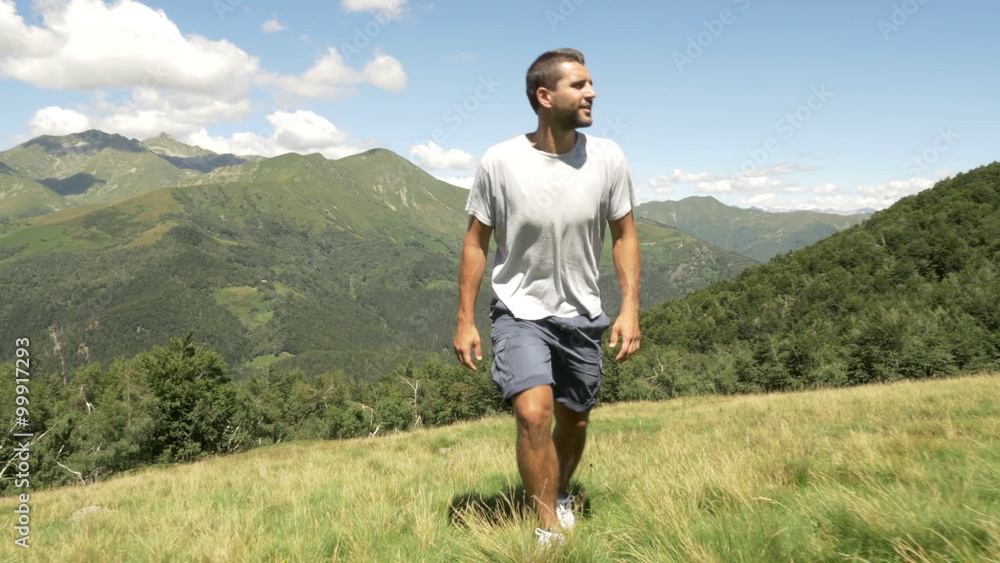 Front view of man hiking in mountain gimbal steadicam Front view of man hiking in mountain gimbal steadicam