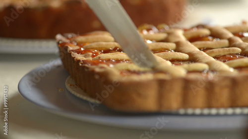 Cutting an italian tart for breakfast    photo