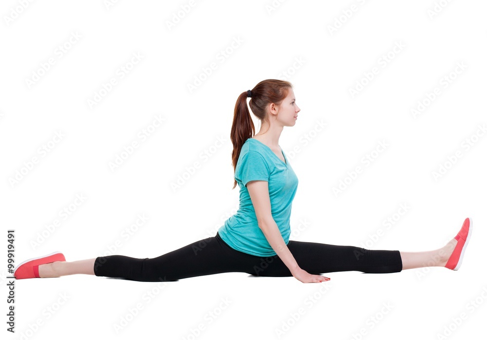 side view of the girl in sportswear sitting on splits. side view of the girl in sportswear sitting on splits.