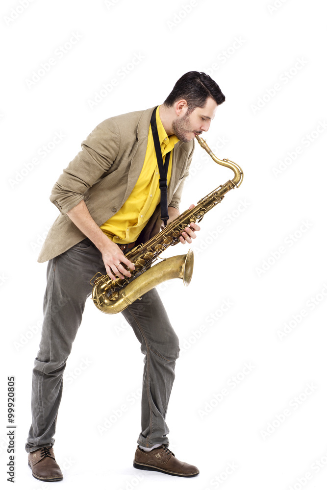 Naklejka premium man saxophonist playing saxophone player in studio isolated on w