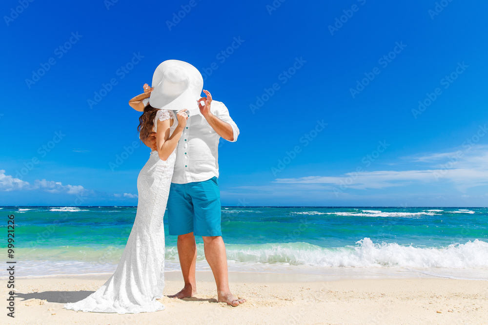 Beautiful brunette bride in white wedding dress and straw hat an Beautiful brunette bride in white wedding dress and straw hat an