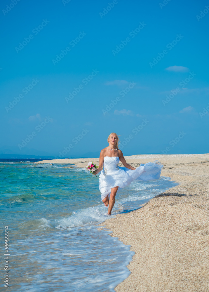 Beautiful young bride walking on the beach Beautiful young bride walking on the beach