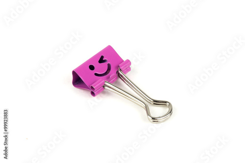Pink happy face paperclip on white background. 
