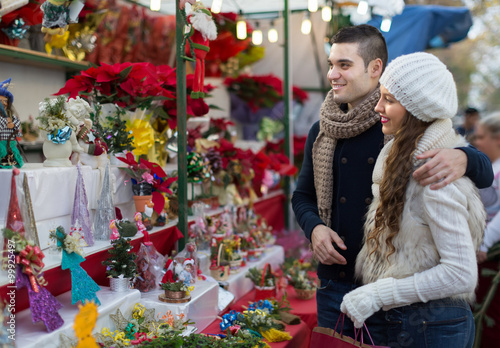 Couple buying Christmas flower at market