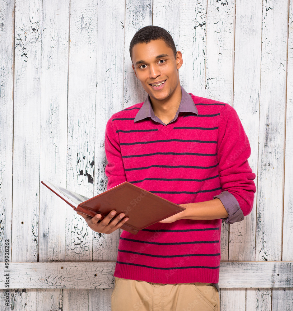 Obraz premium Handsome man with register or journal in studio