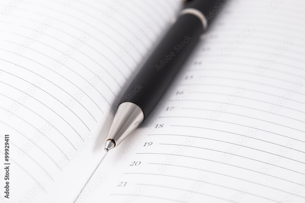Ball pen and office pad, focus on the tip Ball pen and office pad, focus on the tip