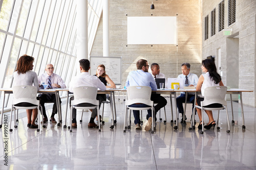 Group Business Meeting Around Table In Modern Office