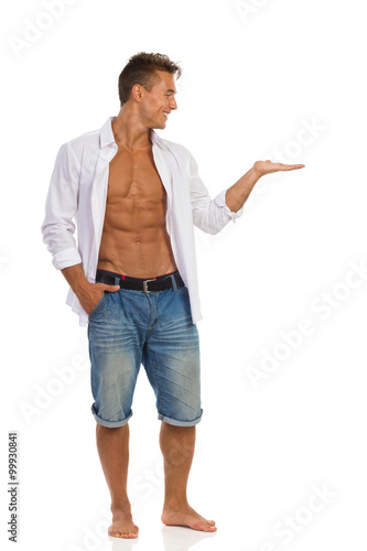 Man In Unbuttoned Shirt Presenting Product