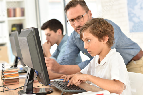 Teacher with kids in computing class