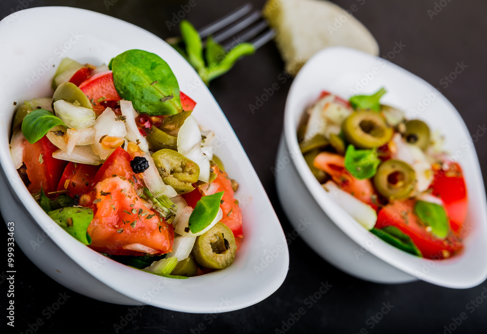 Fresh salad with tomatoes, lamb's lettuce, olives and onion Fresh salad with tomatoes, lamb's lettuce, olives and onion