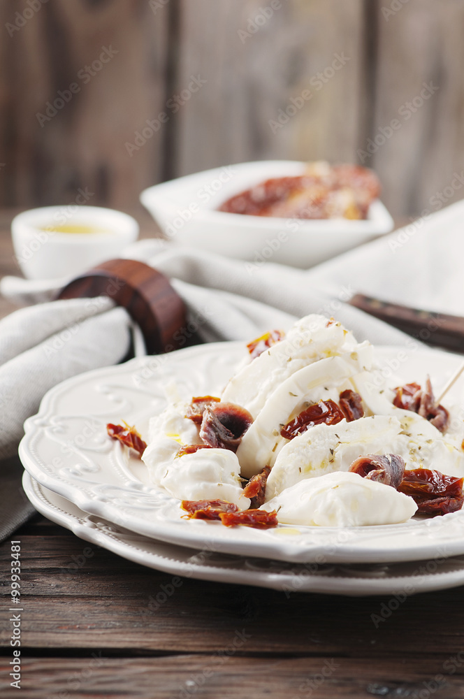Traditional italian antipasto with burrata and dry tomato Traditional italian antipasto with burrata and dry tomato