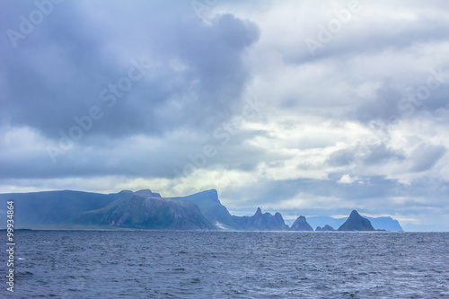 Beautiful view of stormy sky and sea with mountain landscape behind, Norway