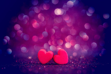 red Heart shapes on abstract light glitter background 