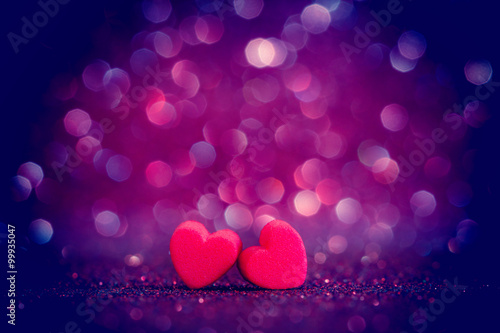 red Heart shapes on abstract light glitter background 