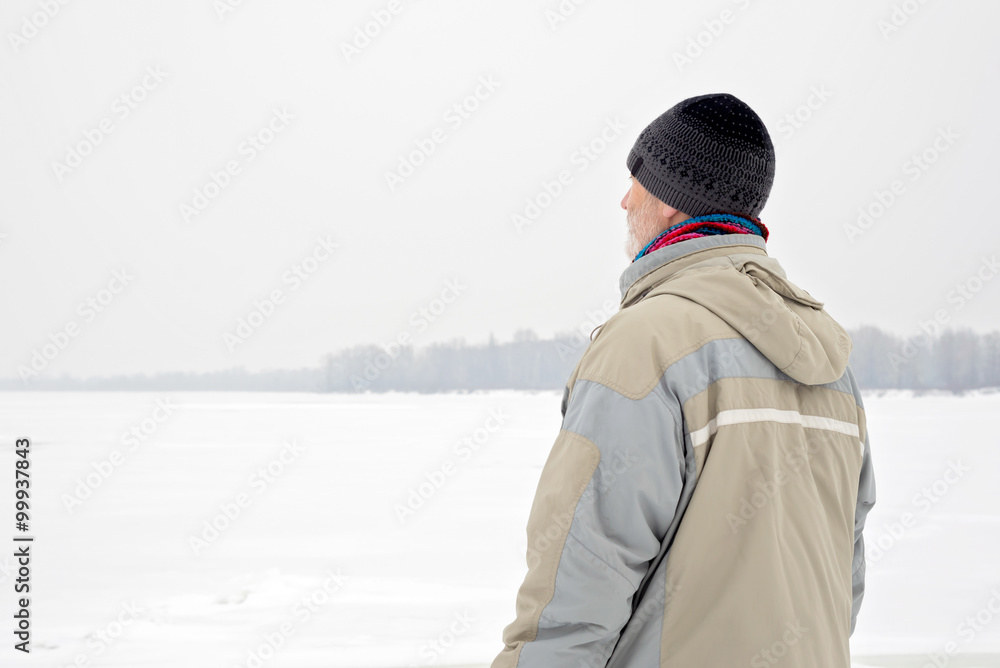 Man Close to the Frozen River in Winter