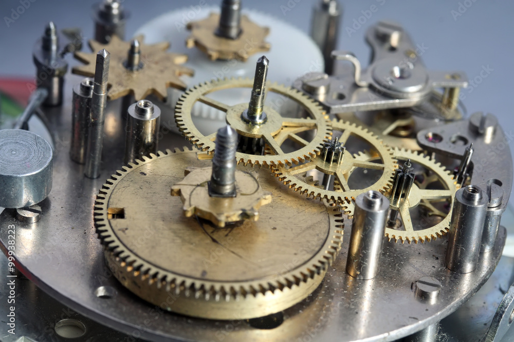 the old clock mechanism with metal gears and screws