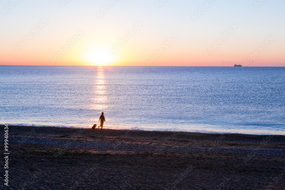 Person traveling Woman walking on Ocean Beach at Sunrise