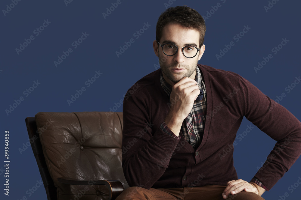 Young thoughtful man against blue background Young thoughtful man against blue background