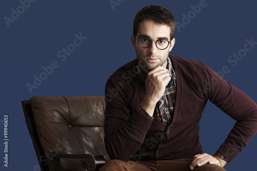Young thoughtful man against blue background © sanneberg