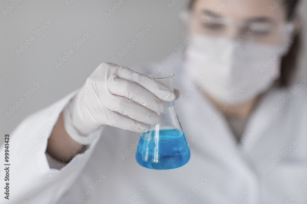 Fototapeta premium close up of woman with flask making test in lab