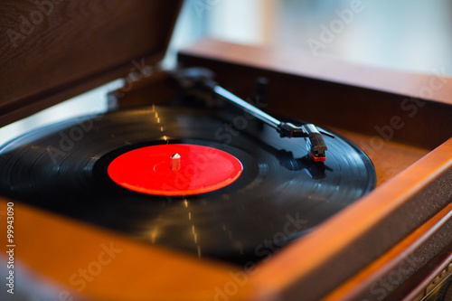 close up of vintage record player with vinyl disc photo