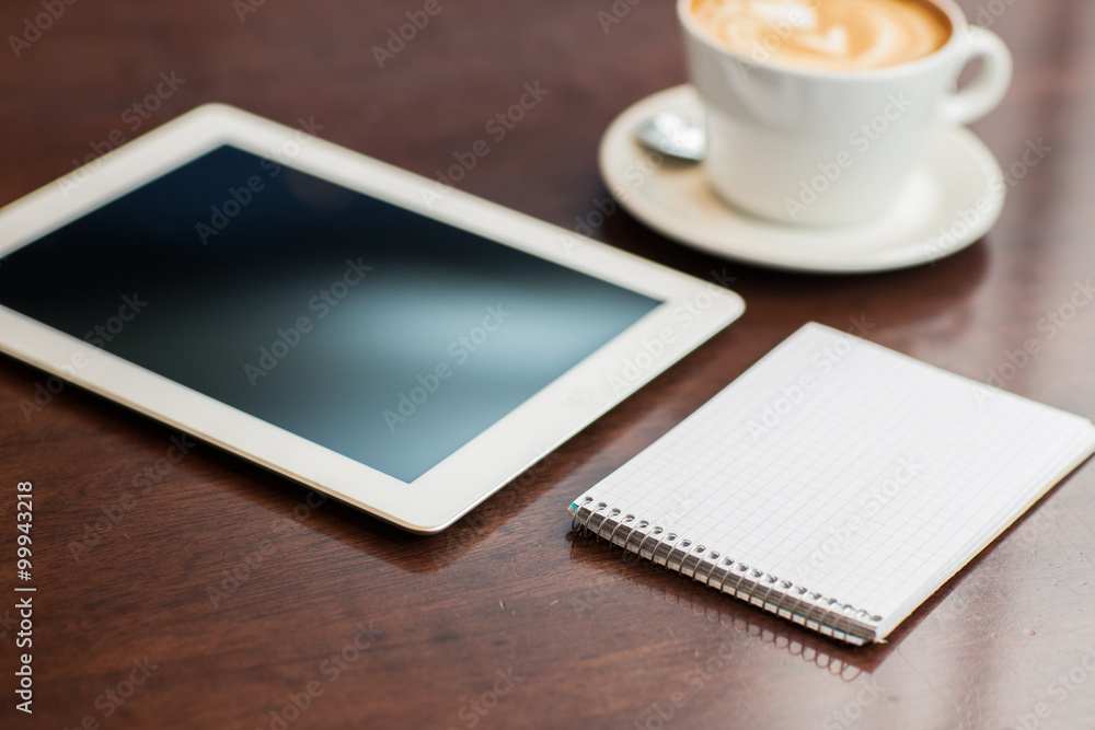 close up of notebook with tablet pc and coffee close up of notebook with tablet pc and coffee