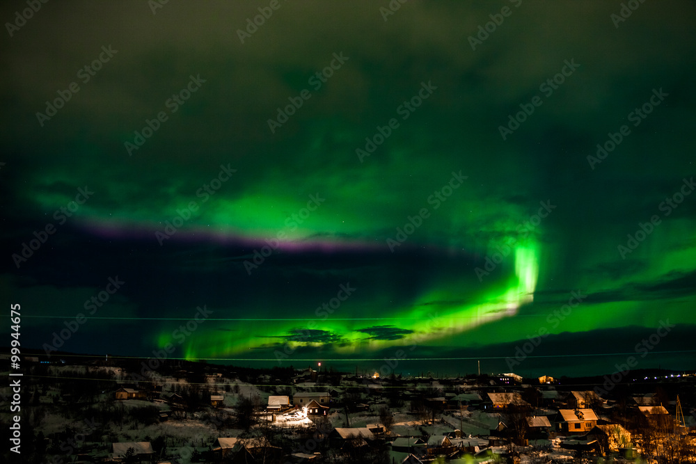 Nothern lights over smal village. Aurora Borealis