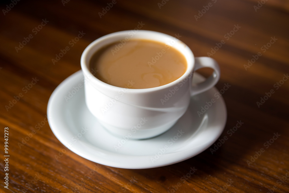 Cup of coffee with milk on a wooden table Cup of coffee with milk on a wooden table