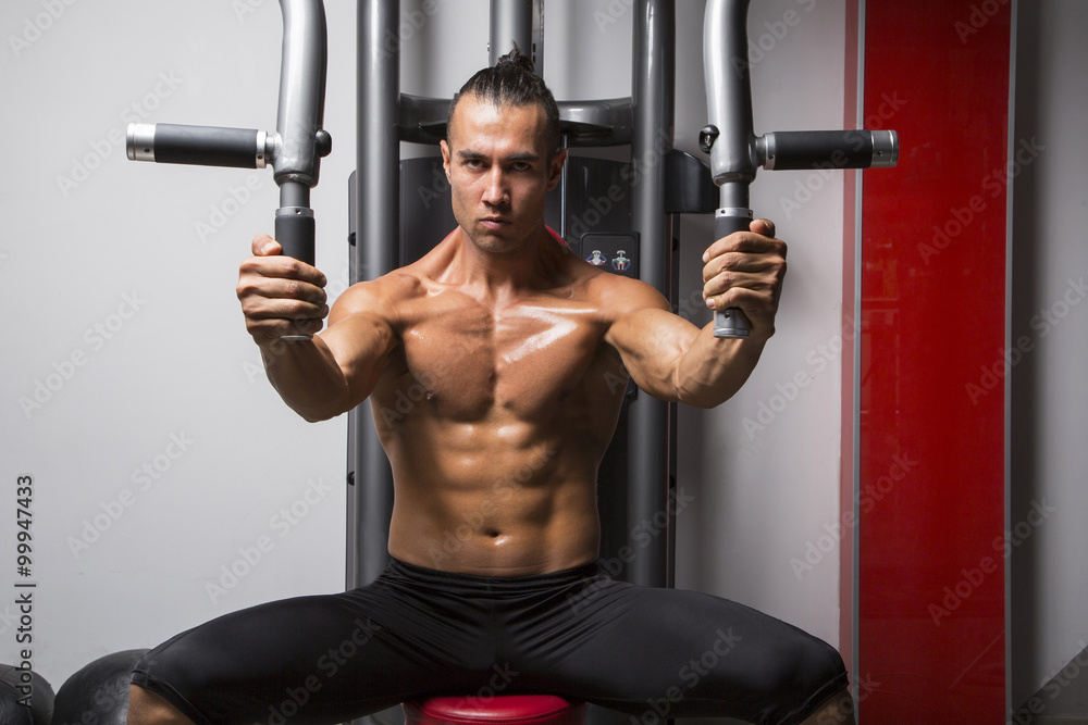 Young muscular man in gym Young muscular man in gym