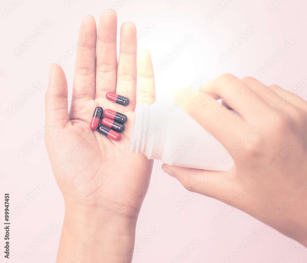 hands holding medicine capsule hands holding medicine capsule