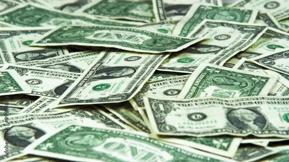 Panning shot of scattered American money.