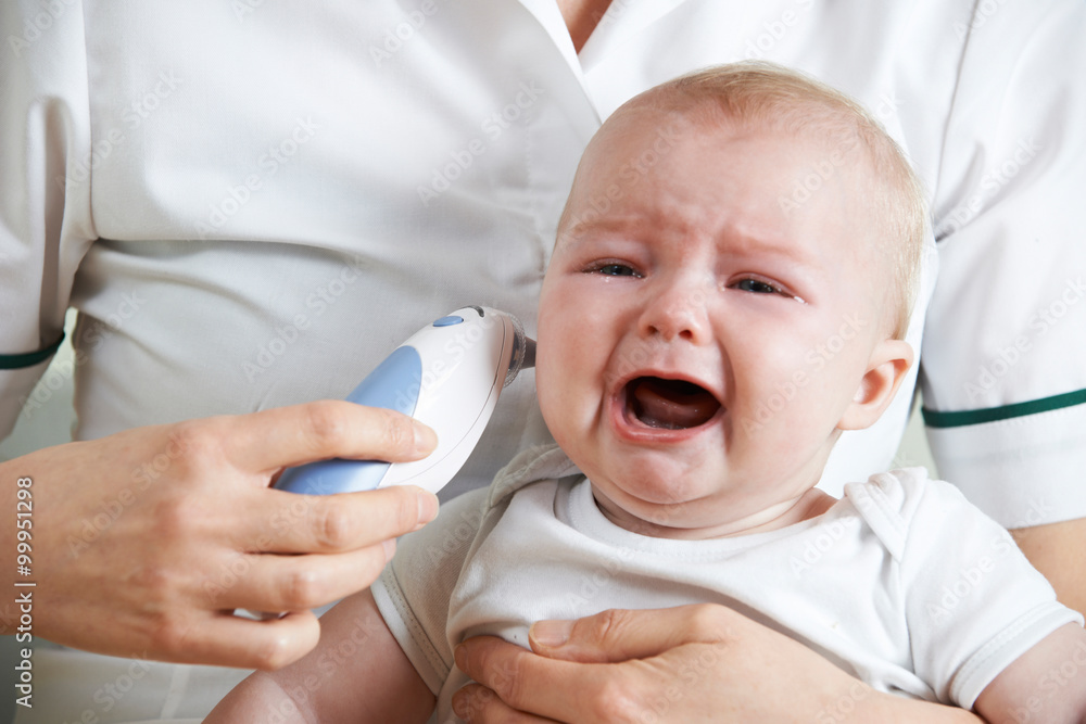 Nurse Taking Crying Baby's Temperature With Digital Thermometer Stock