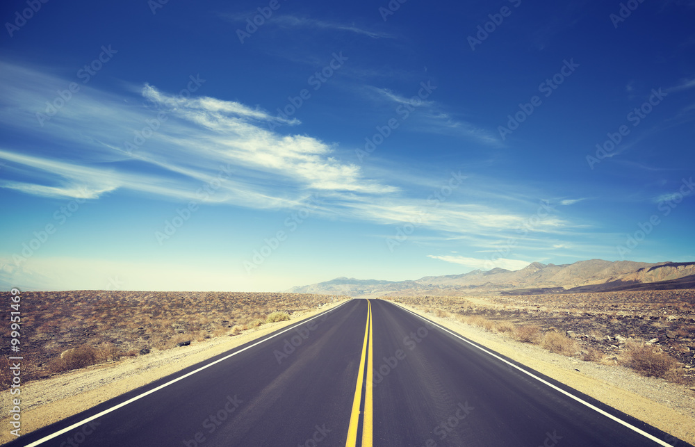 Vintage toned endless country highway, Death Valley, USA.